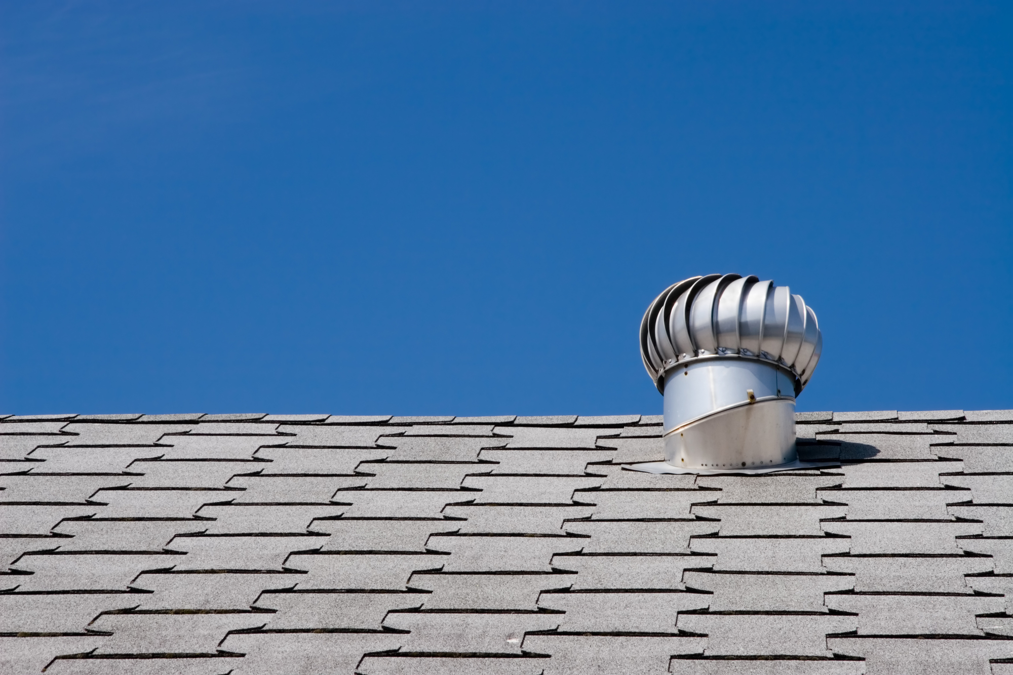 Roof of commercial building with exhaust vent.